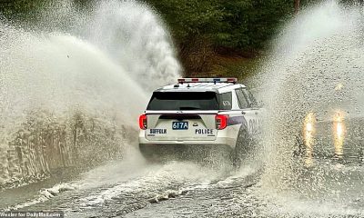 A Suffolk County police car is pictured powering through a flooded area of New York on January 16 after the ongoing Saskatchewan Screamer storm flooded coastal regions on the east coast and caused snowstorms inland