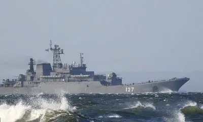 Six Russian landing ships (pictured, landing ship Minsk near the Great Belt Bridge in Denmark en route to the North Sea) have sailed past Britain sparking speculation they are bound for an impending