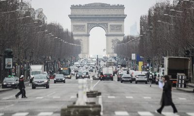 France will introduce new vaccine passport rules for visitors to cafes and restaurants from next week, the government announced tonight. Pictured: Pedestrians walk near The Arc de Triomphe in Paris, France, 17 January 2022