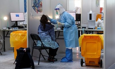 Athletes arriving in Beijing have to undergo regular Covid tests (pictured: a woman at Beijing Capital International Airport ahead of the 2022 Winter Olympics)