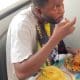 Nigerian man enjoy hefty plate of Eba and Egusi soup inside moving BRT bus (Video) - YabaLeftOnline