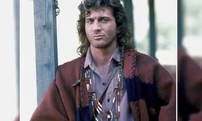 Joe Lando, with long hair, posing for a picture