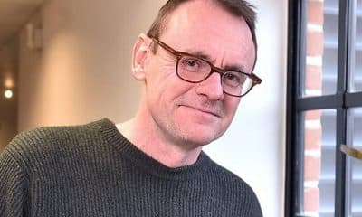 Sean Lock sports his glasses while posing for a picture.