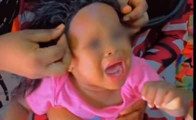 "Let kids be kids" – Nigerians react to video of a mum getting a wig installed on her baby for an event (video) - YabaLeftOnline